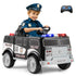 Child in a police uniform sitting in a toy police car with a remote control on a white background