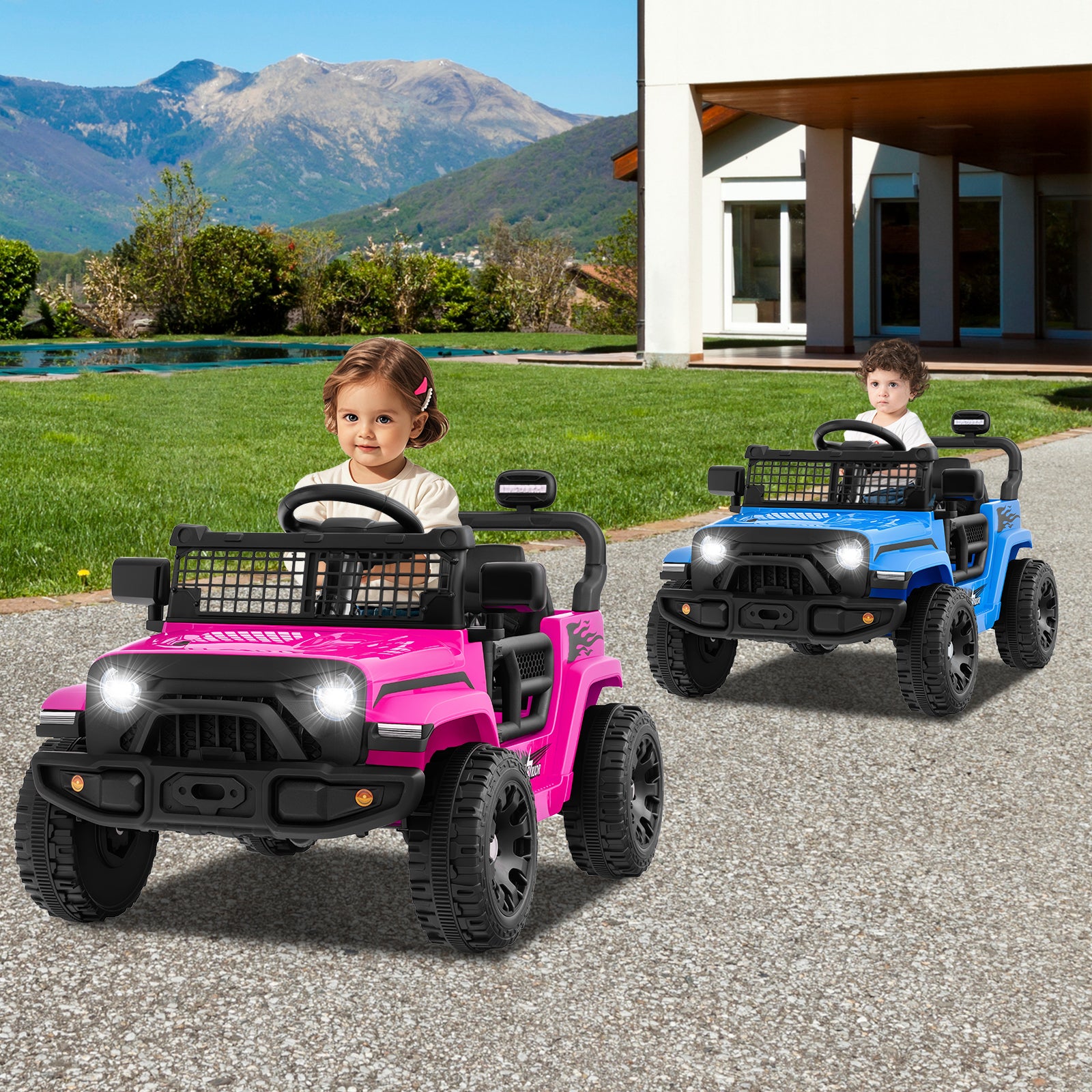 Two children playing with pink and blue toy cars on a driveway with mountains in the background.