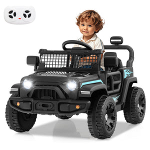 Child sitting in a toy black off-road vehicle with a remote control on a white background