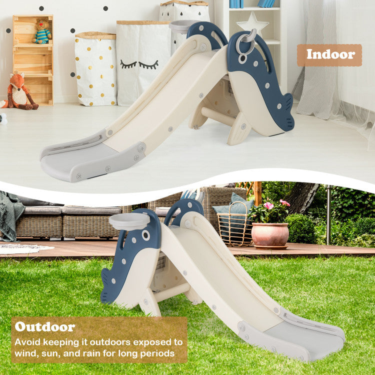 A children's indoor/outdoor plastic slide shown in two settings: a white room with storage bins and toys in the top half, labeled 'Indoor,' and a grassy backyard in the bottom half, labeled 'Outdoor.' The slide has a cream body with dark blue whale-shaped side panels and a gray footrest.