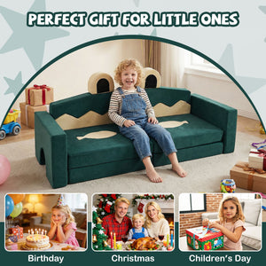 Child sitting on a green play couch with festive decorations and family photos.