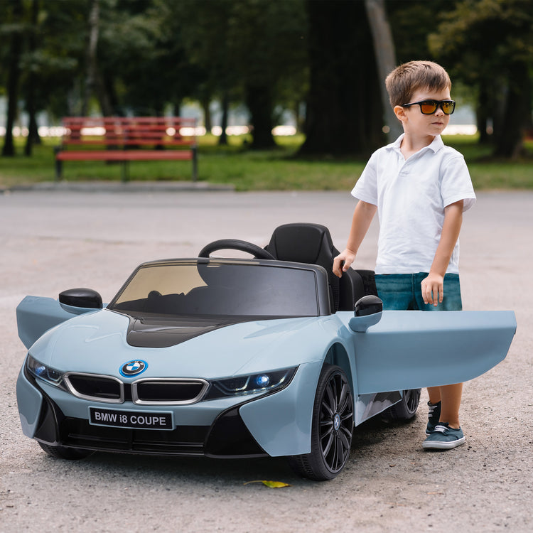 Licensed BMW I8 kids ride-on car in blue color for ages 3–8.