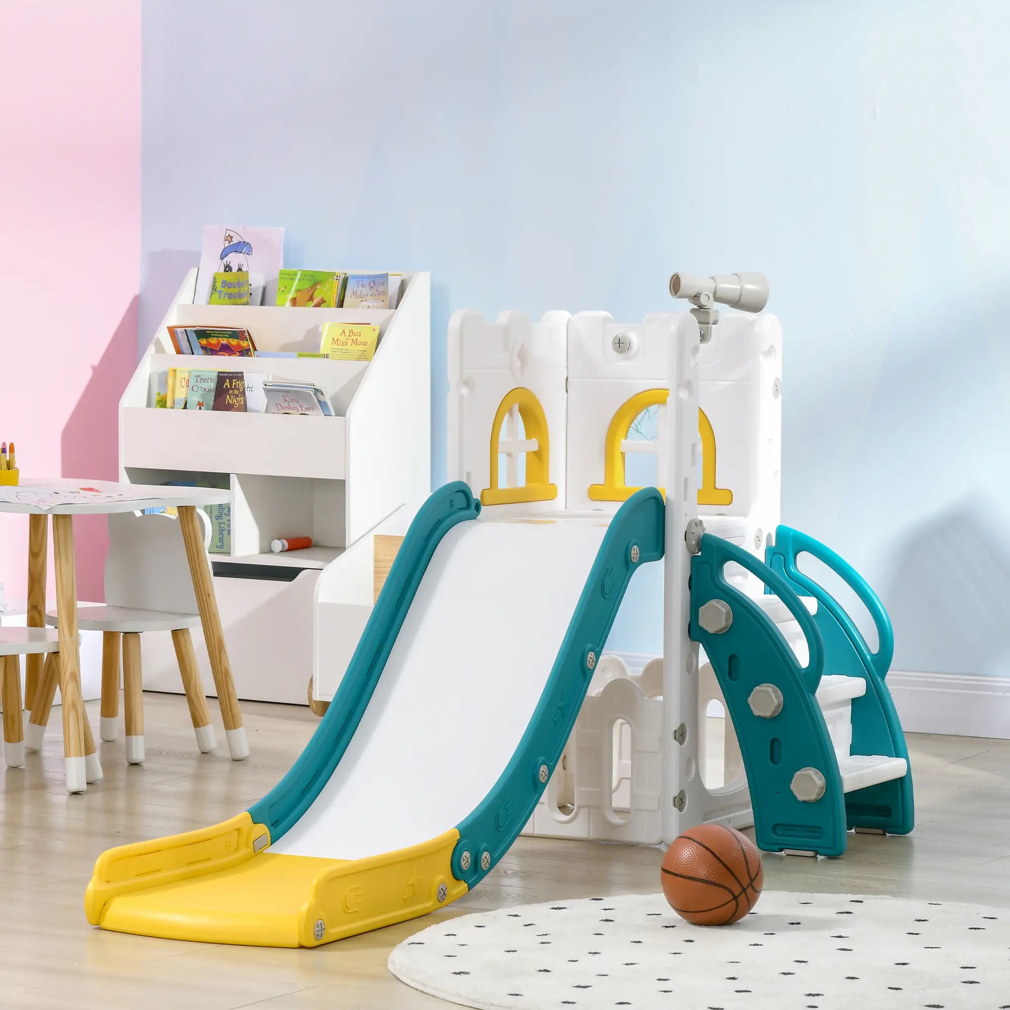 Children's play area with a slide, climbing structure, and books in a room.