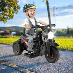Child riding a toy motorcycle on a road with a scenic background
