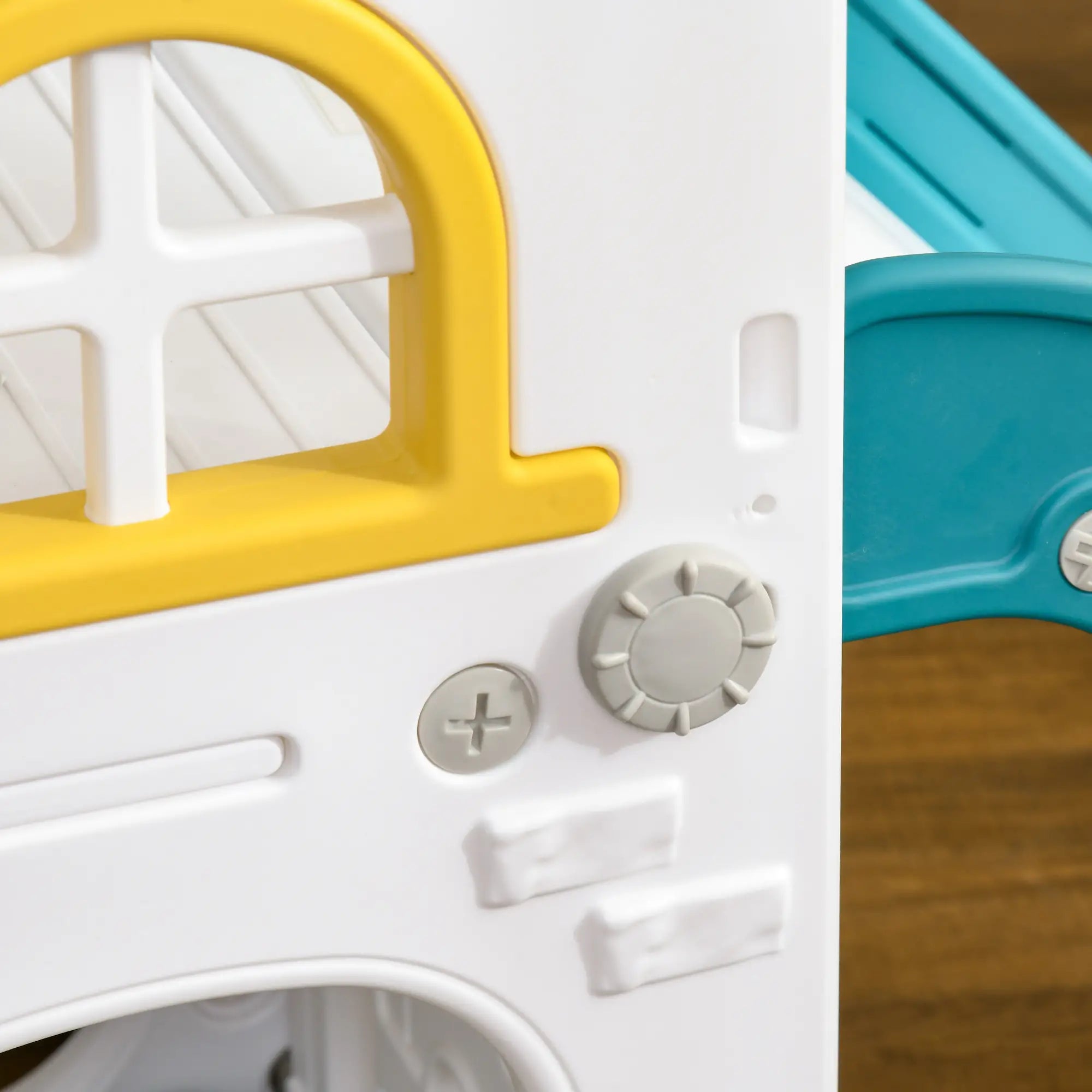 Close-up of a toy vehicle with yellow roof and white body, featuring buttons and a steering wheel.
