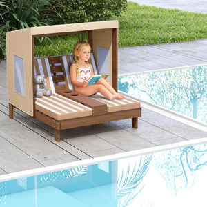 Child sitting on a wooden poolside chair with canopy by a pool