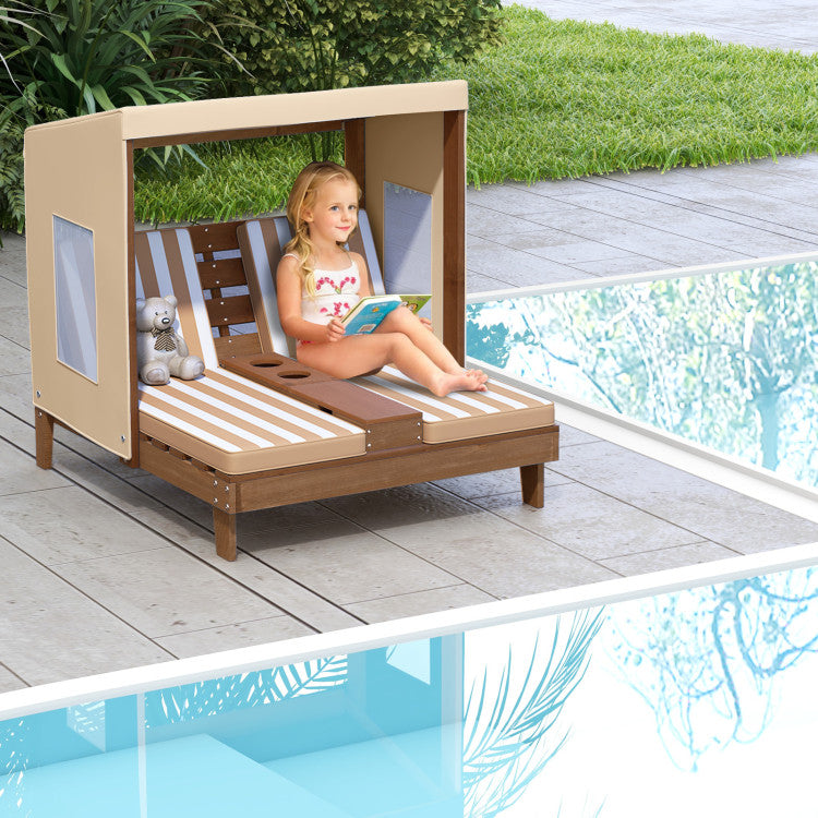 Child sitting on a wooden poolside chair with canopy by a pool