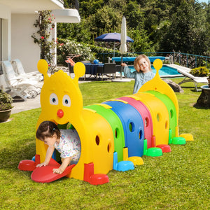 Colorful caterpillar-shaped slide in a backyard setting with children playing.