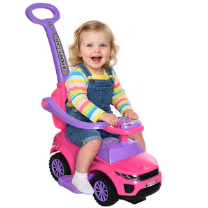 Child sitting in a pink and purple toy car with a white background