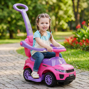 Child sitting in a pink and purple toy car outdoors
