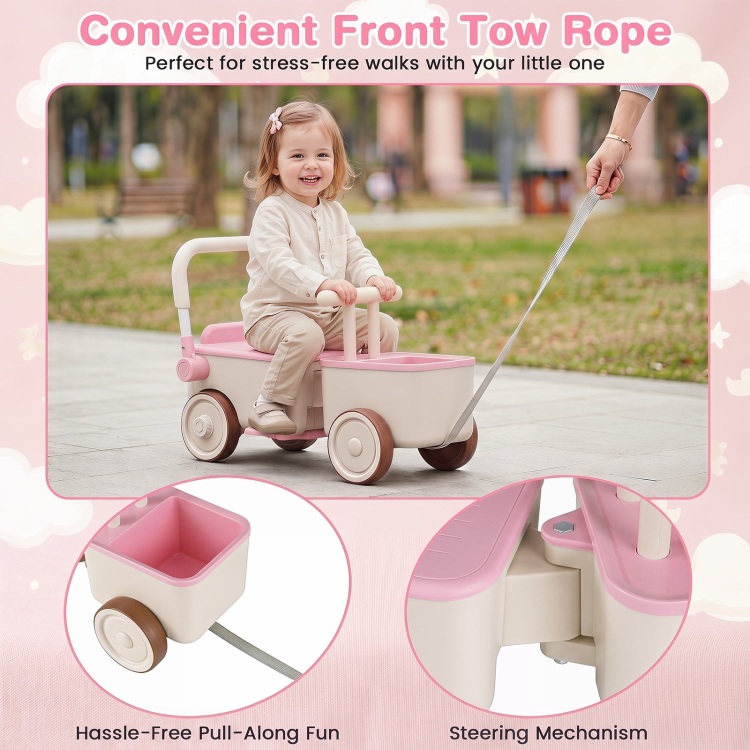 Child riding a pink and beige toy stroller with a front tow rope in a park setting.