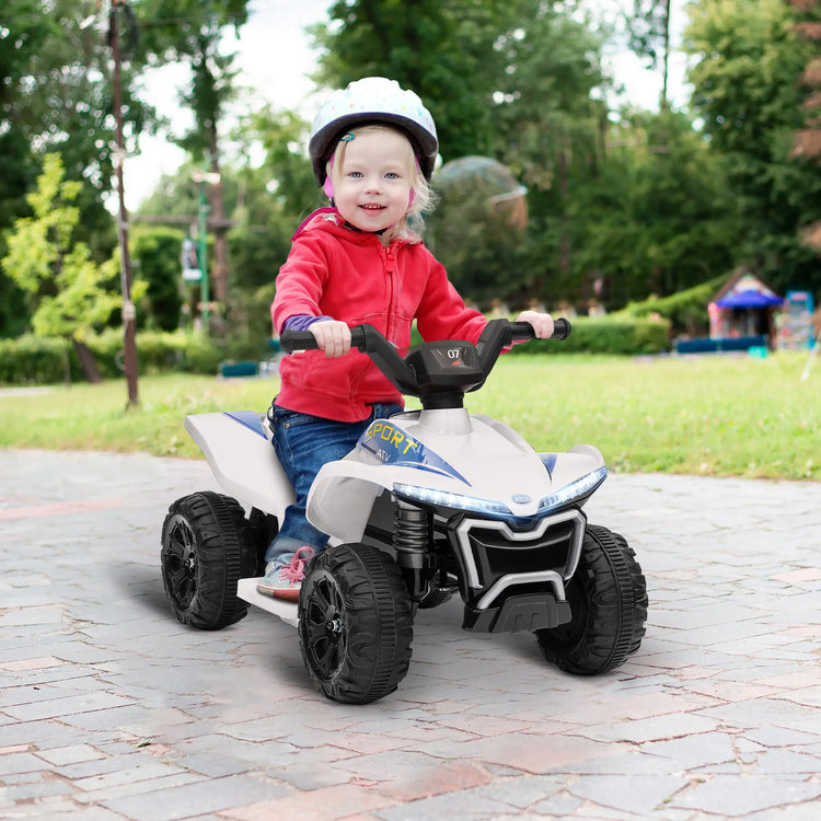 Qaba 6V toddler ATV in white driving on cement road surface with stable and durable tires