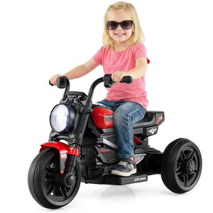 Child riding a red and black toy motorcycle on a white background