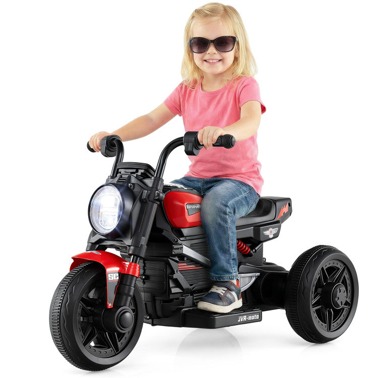 Child riding a red and black toy motorcycle on a white background