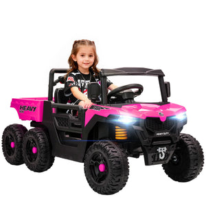 Child sitting in a pink and black toy truck on a white background
