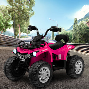 Pink toy ATV on a road with trees and mountains in the background