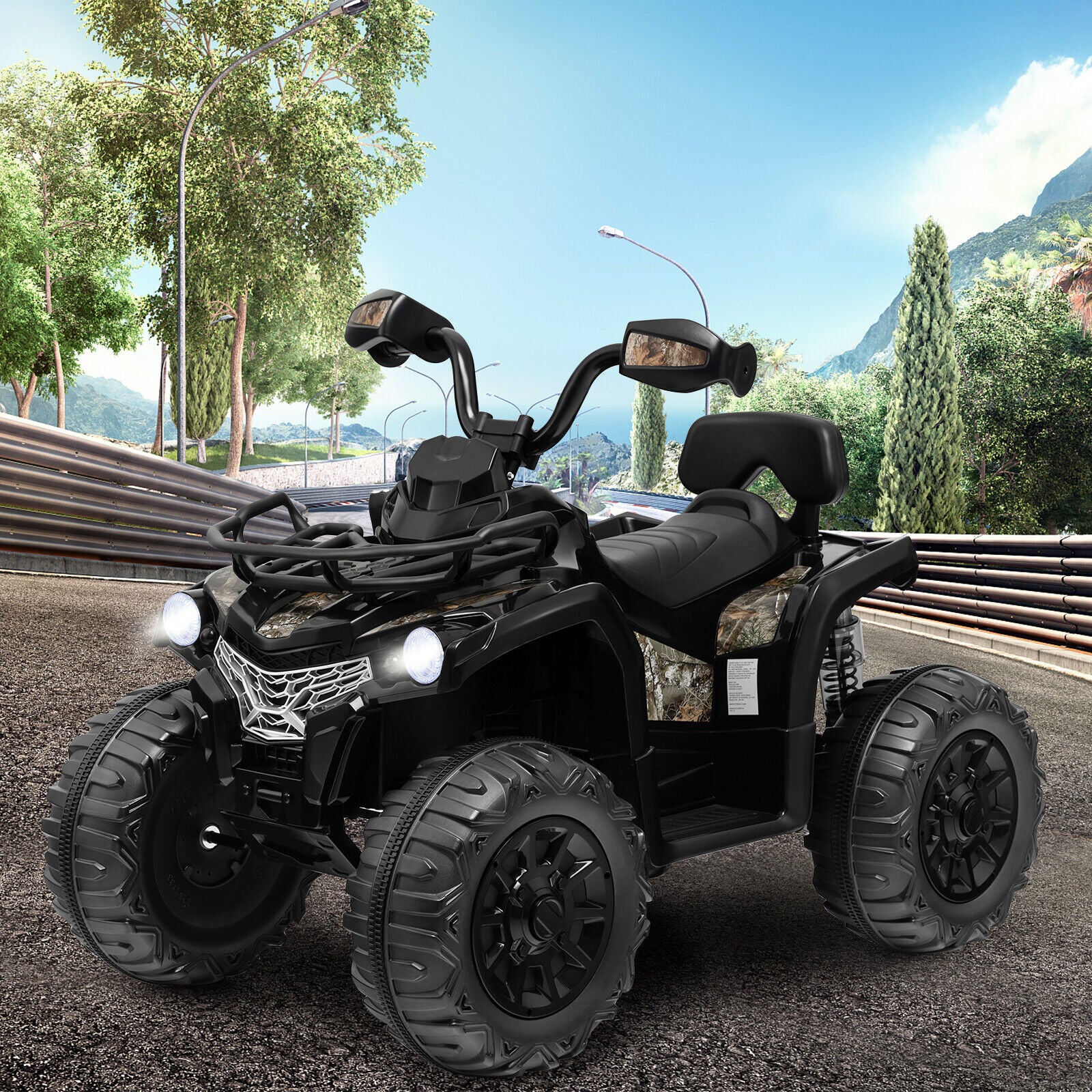 Black ATV on a road with trees and mountains in the background