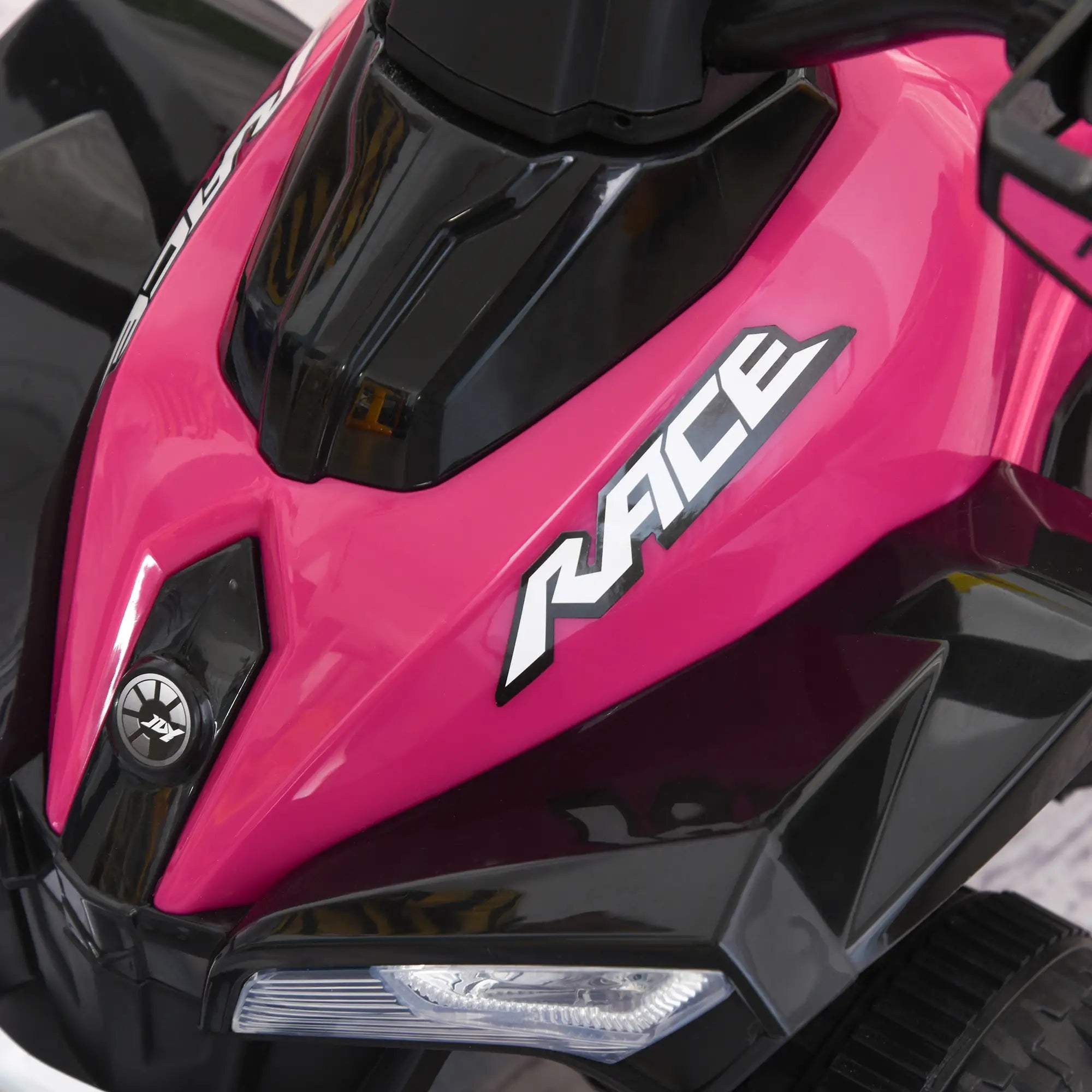 Close-up of a pink and black toy car with 'RACE' branding.