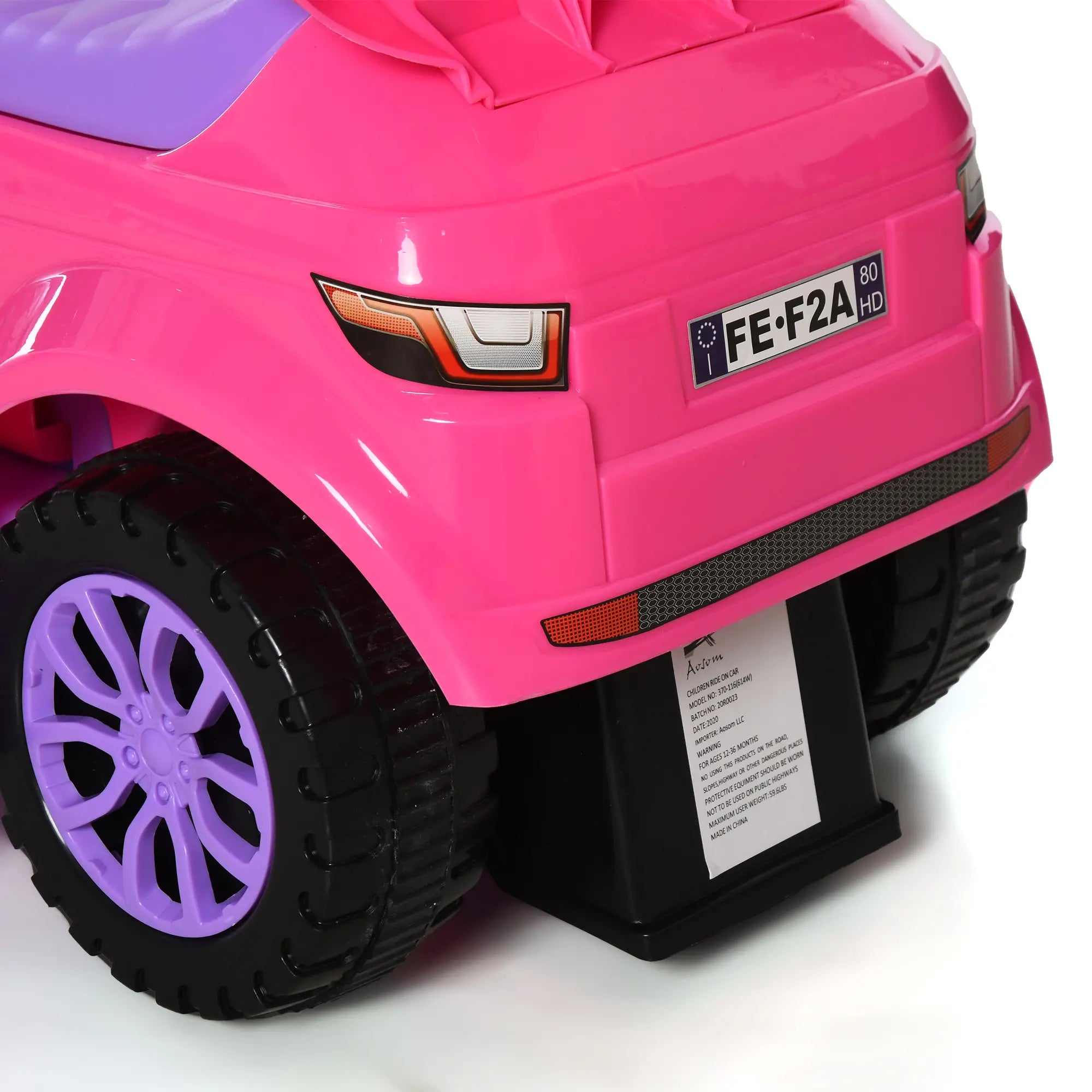 Close-up of a pink toy car with purple wheels on a white background
