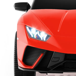 Close-up of a red sports car's front headlight on a white background