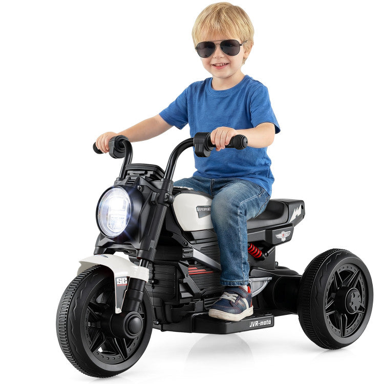Child riding a toy motorcycle with lights on a white background