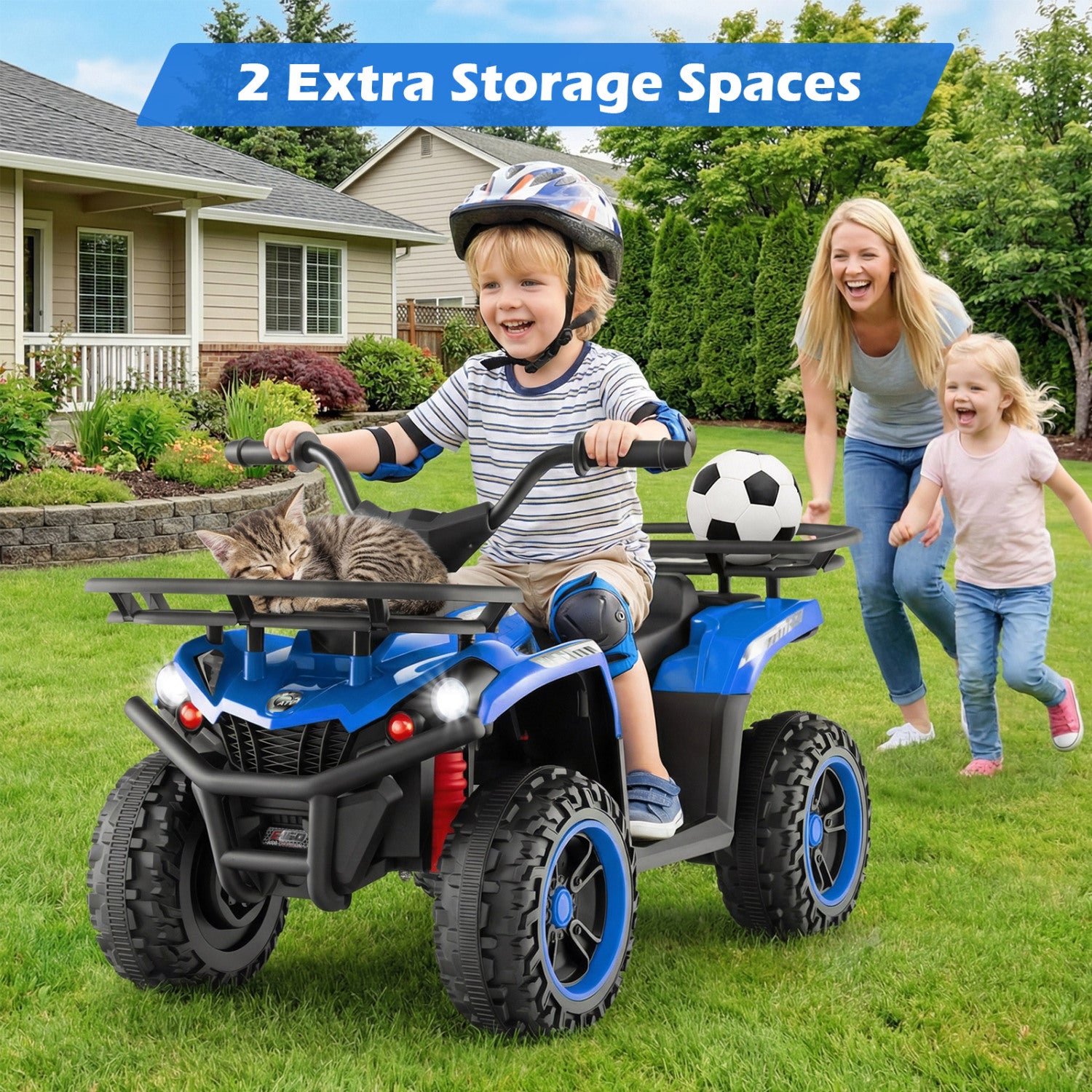 Child riding a blue toy ATV with a cat, woman, and child in the background on a grassy area.