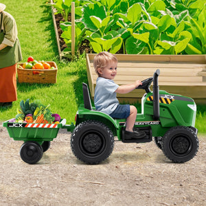 Child playing with a green toy tractor and trailer in an outdoor setting