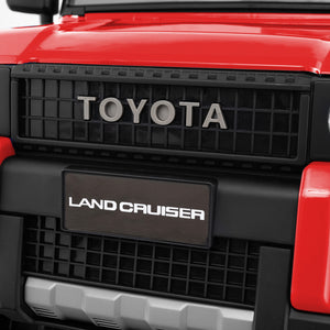 Close-up of a Toyota Land Cruiser grille with 'Toyota' and 'Land Cruiser' branding.