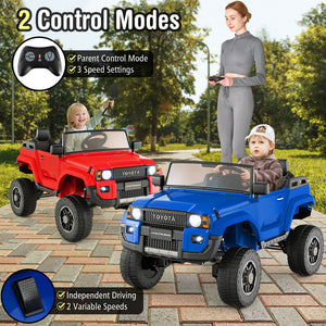 Two toy cars, one red and one blue, with a woman and two children outdoors.
