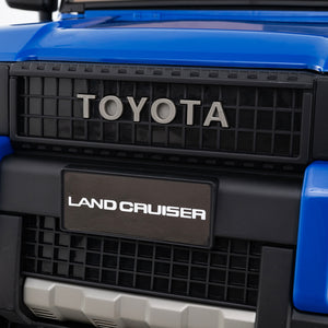 Close-up of a Toyota Land Cruiser grille with 'Toyota' and 'Land Cruiser' branding.