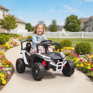 Child in a toy car on a sidewalk with a garden and houses in the background