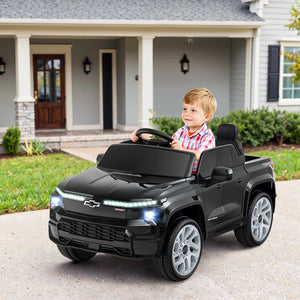 Child playing with a toy car in front of a house