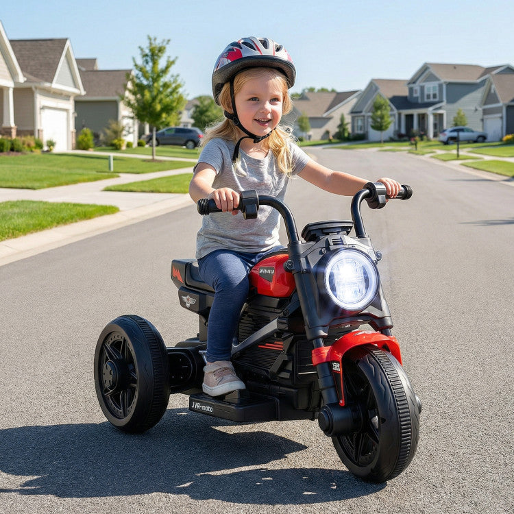 Child riding a red and black toy motorcycle on a suburban street.