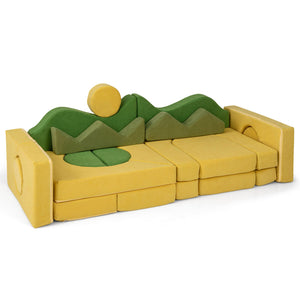 Toy sofa with green mountains and yellow sun on a white background