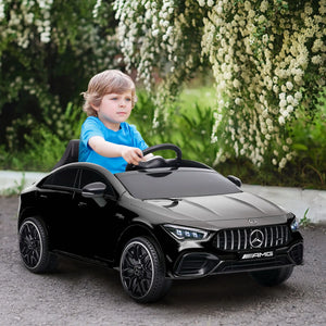 Toddler riding Mercedes-Benz electric car with seatbelt on.