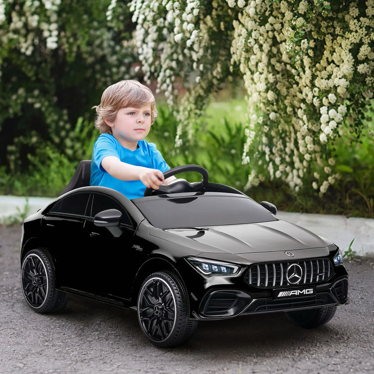 Toddler riding Mercedes-Benz electric car with seatbelt on.