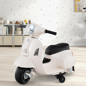 Child enjoying white Vespa ride-on