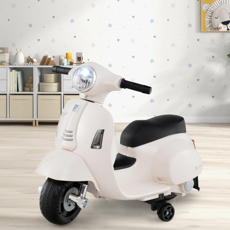 Child enjoying white Vespa ride-on