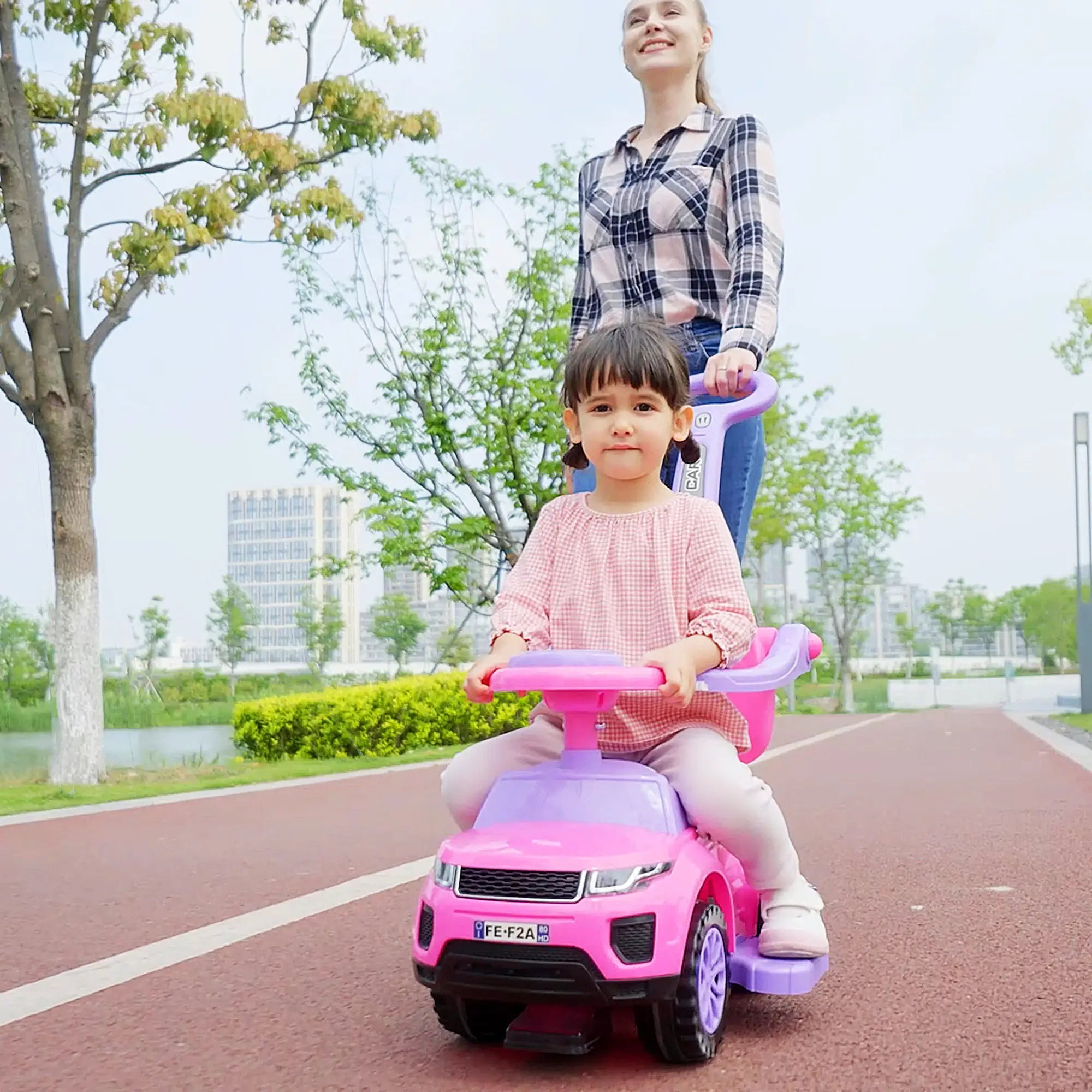 Child playing on pink Aosom ride-on push car
