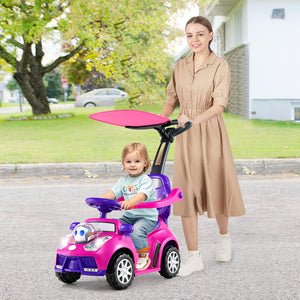 Woman pushing a child in a pink toy car on a street with greenery in the background