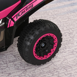Close-up of a pink and black toy car wheel on a textured surface