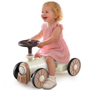 Child playing with a toy car on a white background