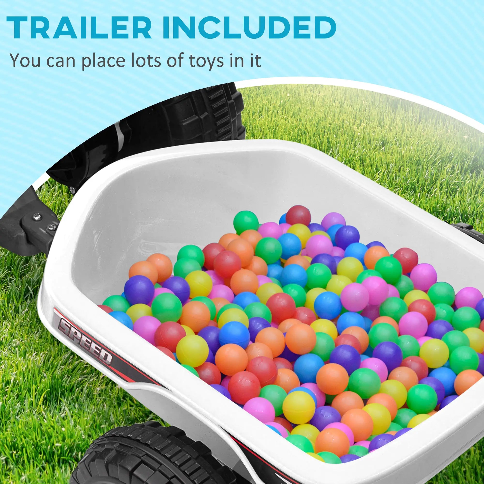 White toy wagon filled with colorful balls on grass, with text 'Trailer Included' above.