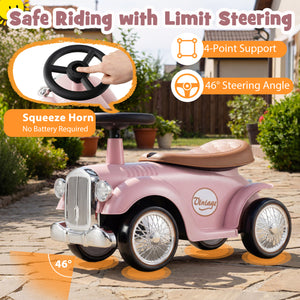 Pink toy car with steering wheel and horn on a patio