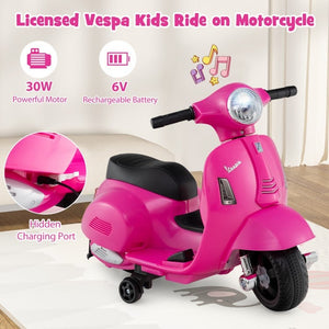 Child riding pink Vespa scooter outdoors
