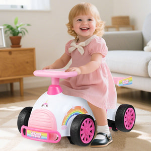 Child in a pink dress riding a toy car in a living room.