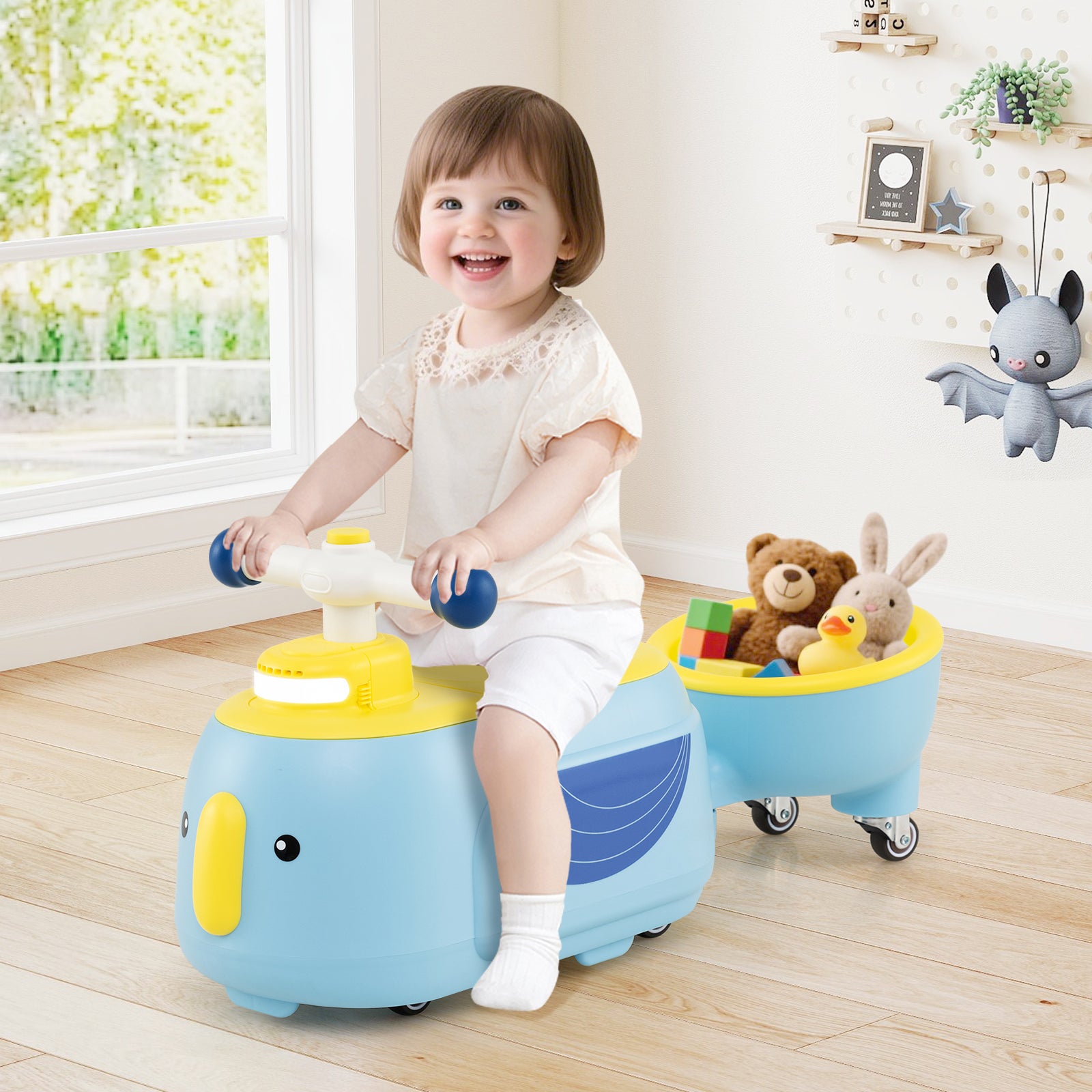 Child playing with a blue and yellow toy whale in a room with toys and decorations.