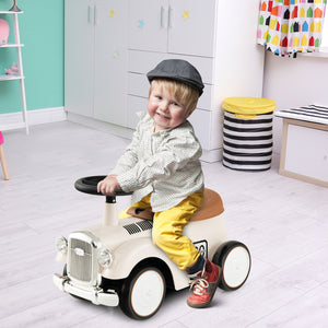 Child sitting on a toy car in a room with colorful walls and toys.