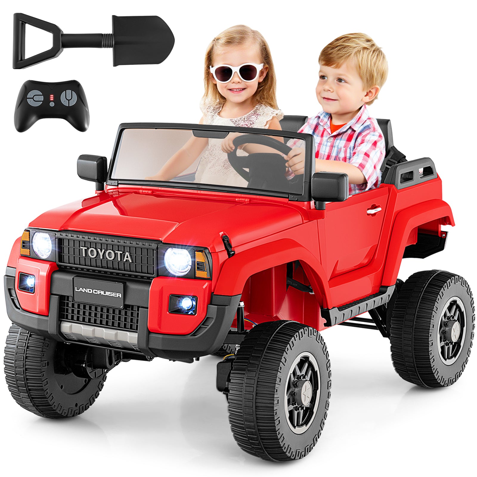 Red toy car with children inside, remote control, and shovel on a white background