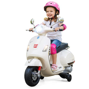 Child on a toy scooter with a helmet and knee pads on a white background